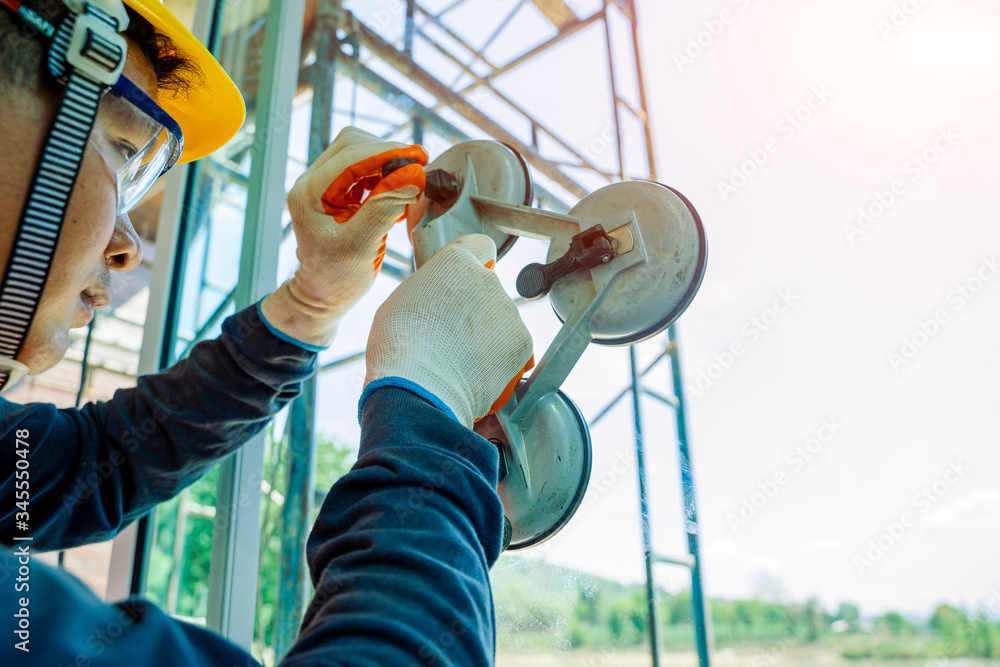 Close up Technician worker at window installation in building construction site.