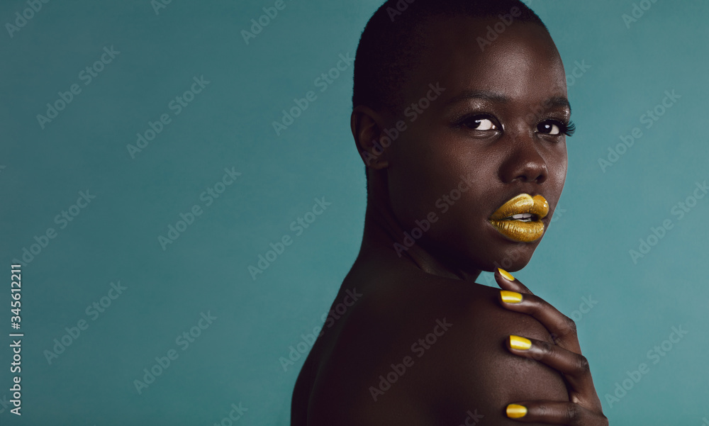 Female fashion model posing against grey background