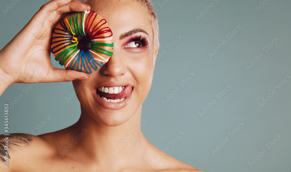 Beautiful female with colorful donut