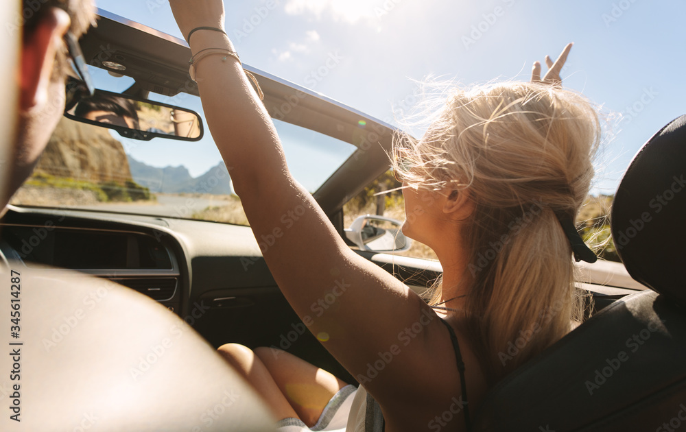 Couple on a road trip in a cabriolet