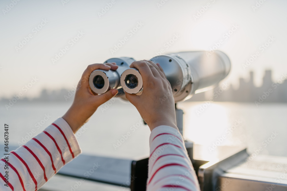 telescope with city skyline