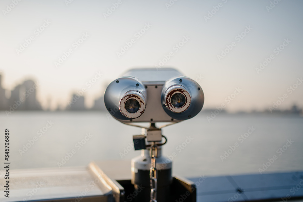 coin operated binoculars with city skyline