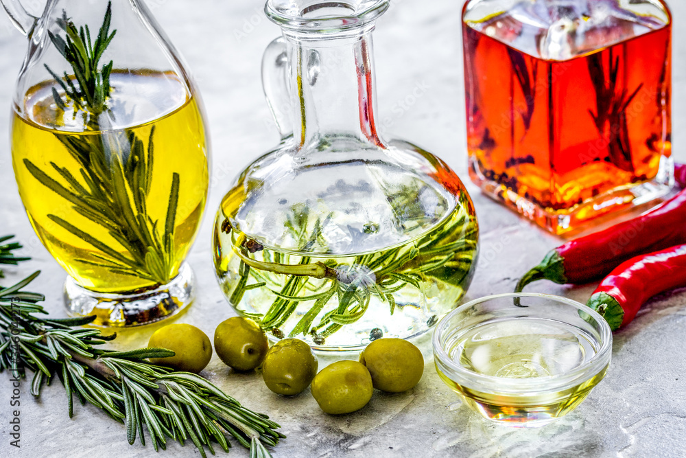 olive, pumpkin seed and chili oil with ingredients on kitchen table background