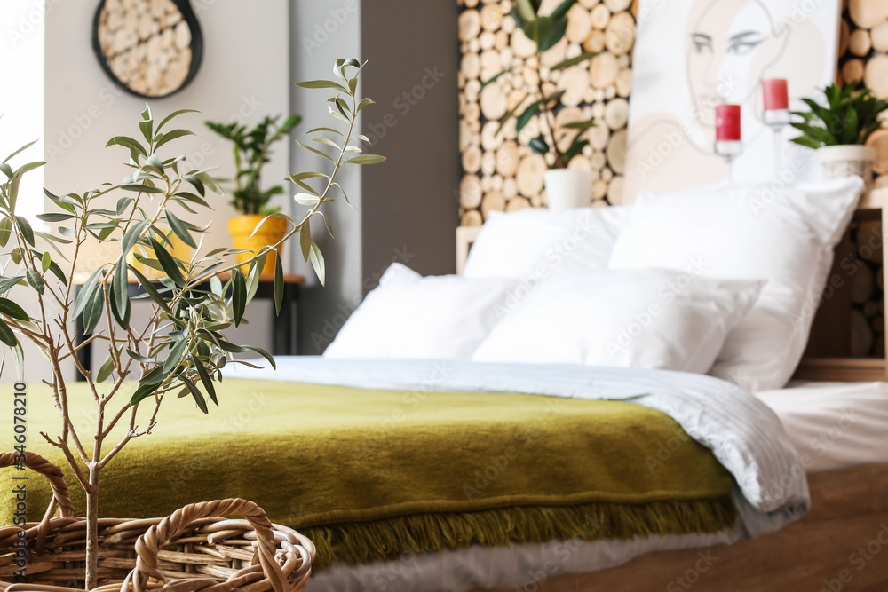 Stylish interior of bedroom with houseplants