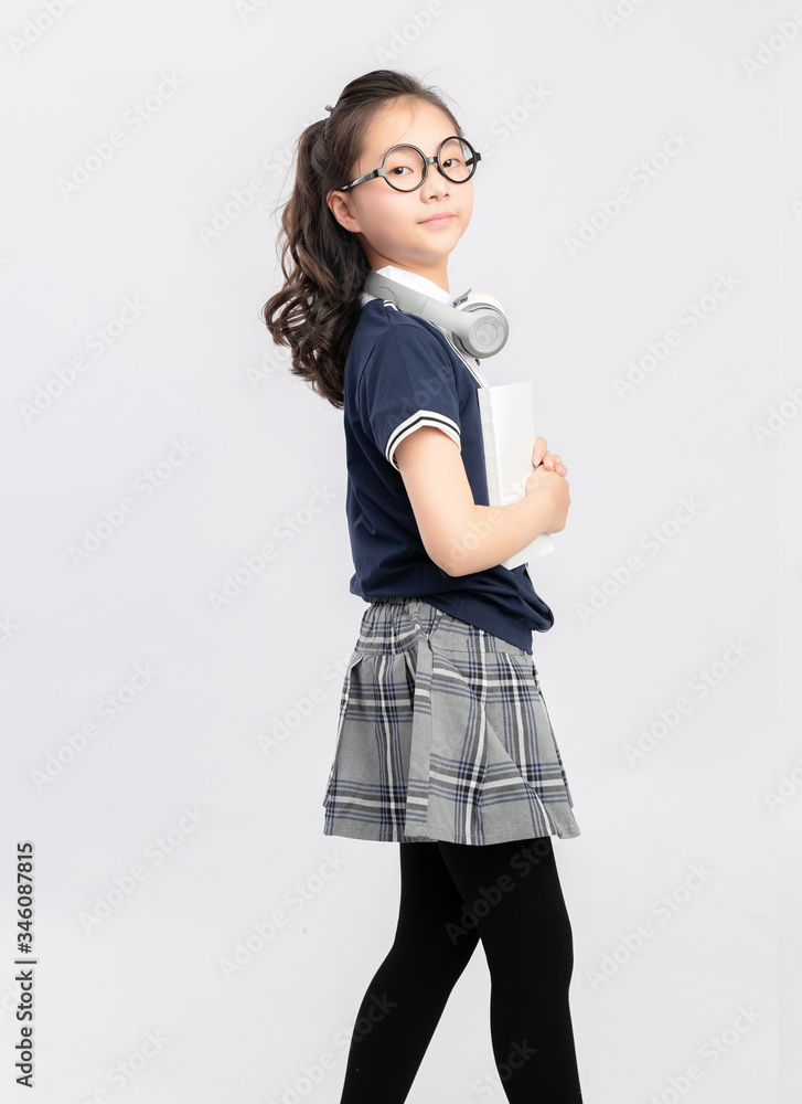 Asian primary  school girls in school uniforms on a gray background