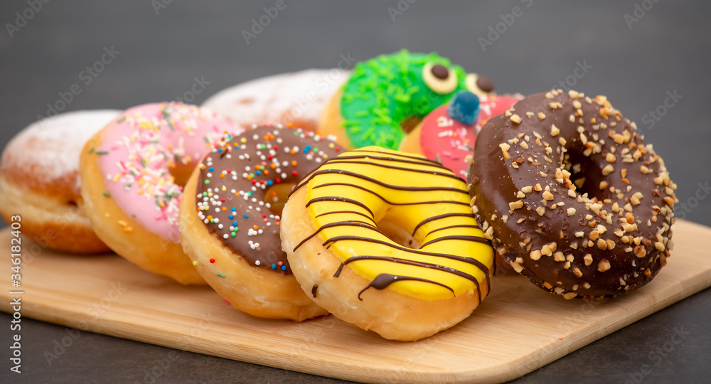 Dessert, Donuts, chocolate and strawberry circles, sugar and cream on Donuts and hot coffee cups, pr