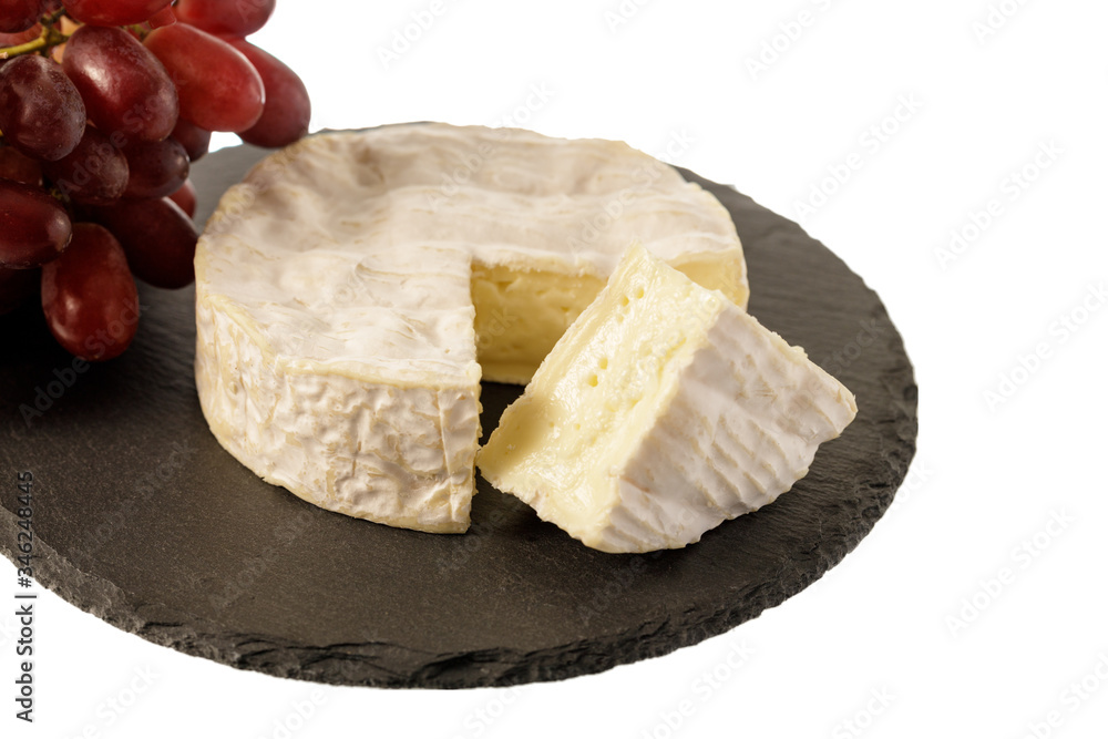 French cheese Camembert on a slate plate isolated on white