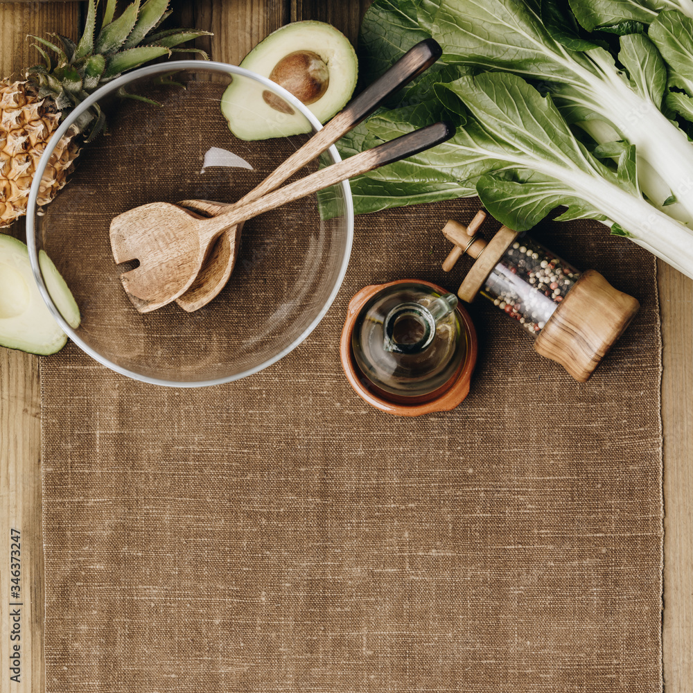 Fresh organic ingredients for salad making on rustic background