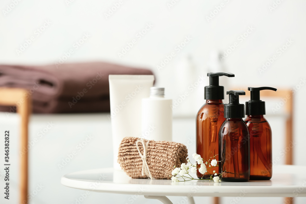 Different shower gels on table in bathroom