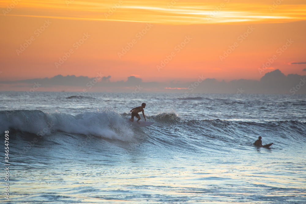 Sunset with surfing in Bali