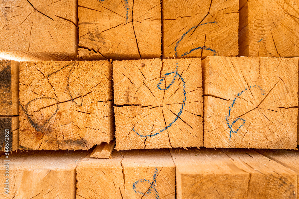 Stack of construction wood planks prepared for build a house