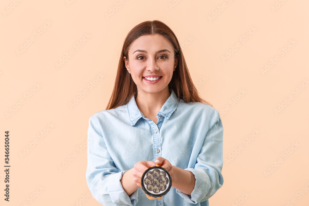 Woman with flashlight on color background