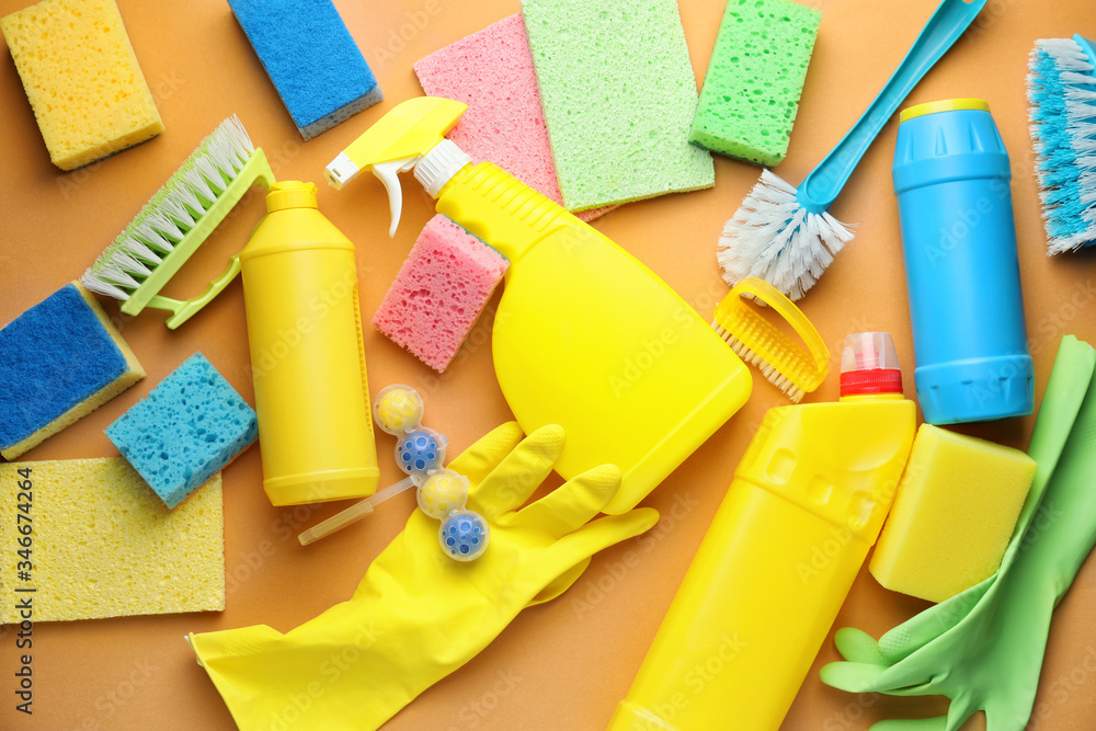 Set of cleaning supplies on color background