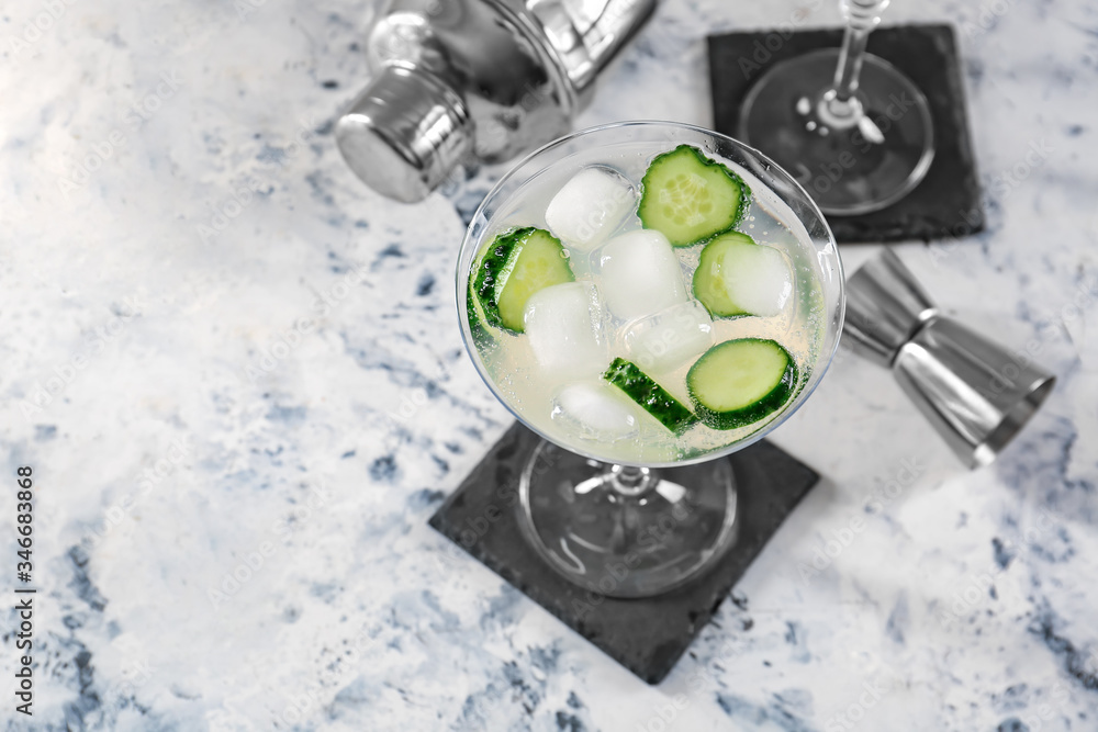 Glass of tasty cucumber martini on table