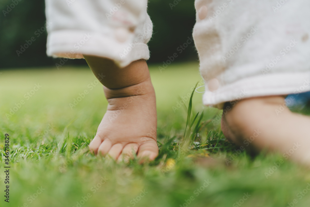 baby walking on grass