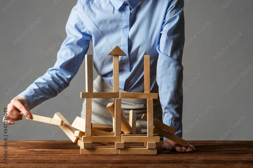 Business woman building tower on table