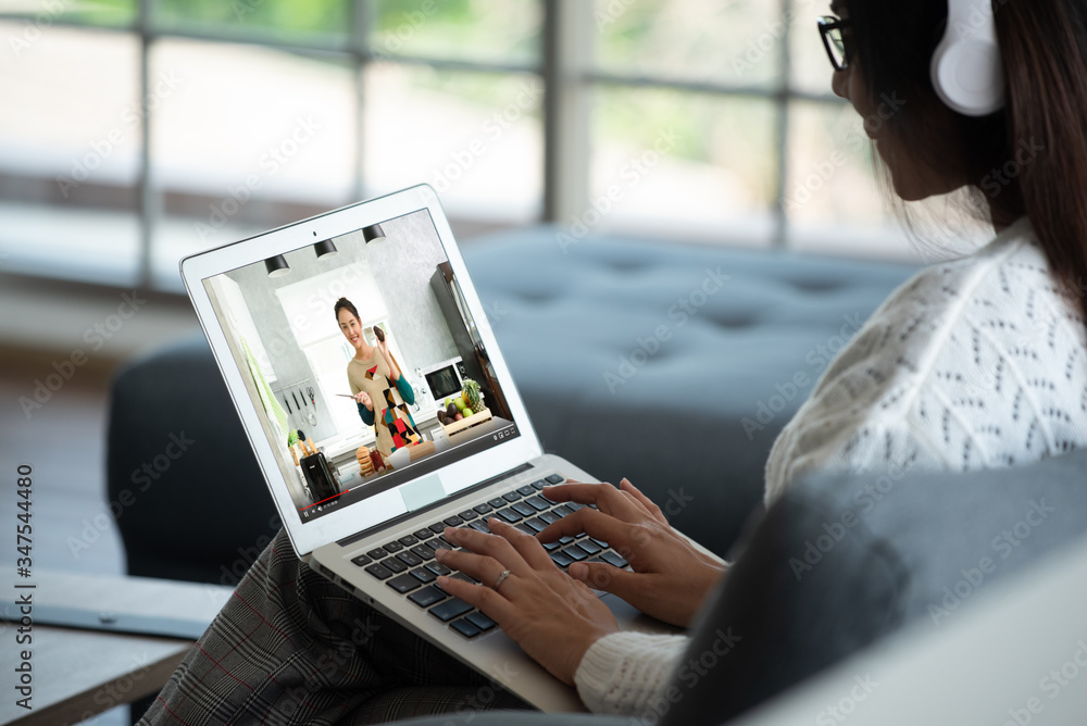 Scene of caucasian woman wear headphone attend an online course during stay at home of city lock dow