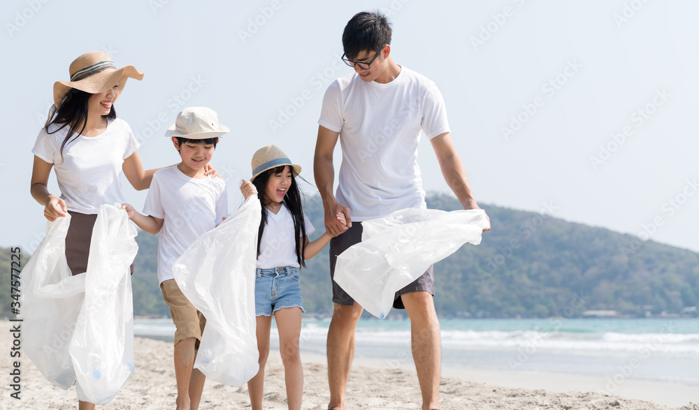 Family volunteer picking up a plastic on a beach protect environment