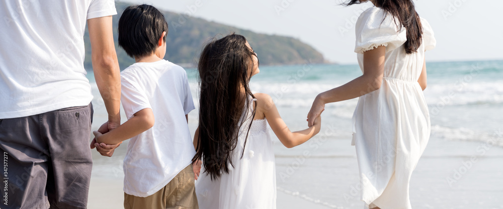 Family walking at beach with kids happy vacation concept