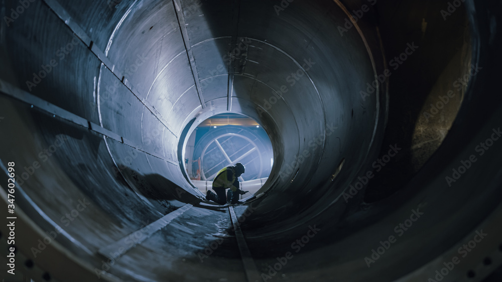 Professional Heavy Industry Welder Working Inside Pipe, Wears Helmet and Starts Welding. Constructio