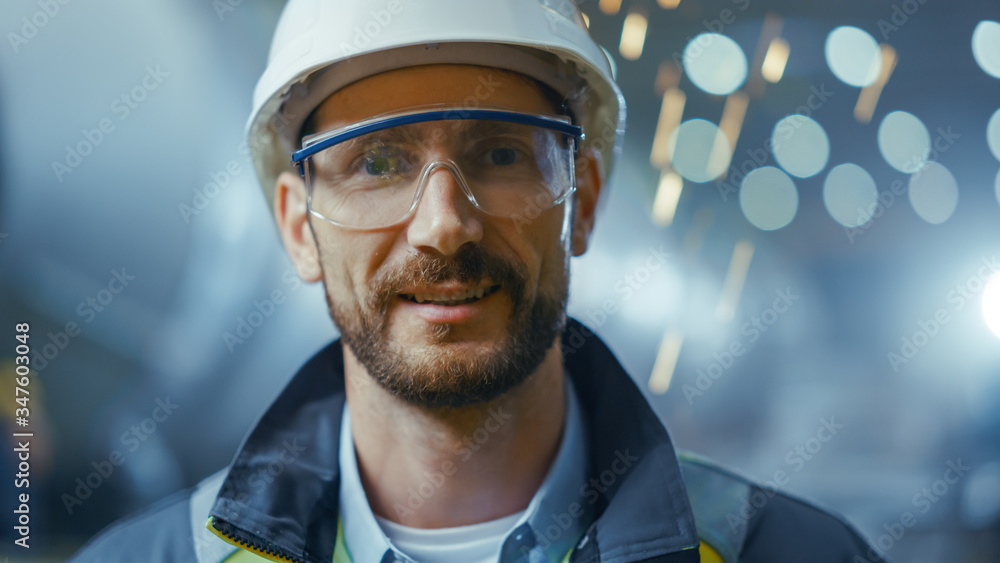 Portrait of Professional Heavy Industry Engineer / Worker Wearing Safety Uniform, Goggles and Hard H