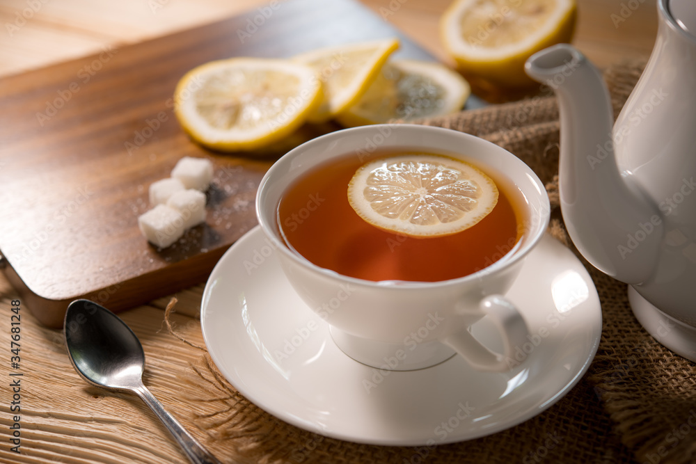 Cup of tea with lemon on wooden table