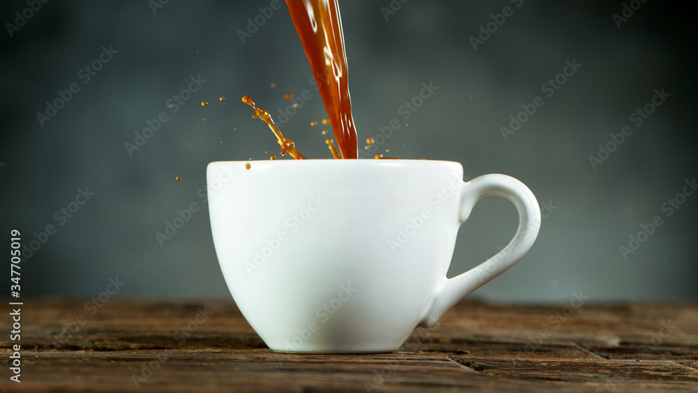 pouring coffee drink with splashing liquid.