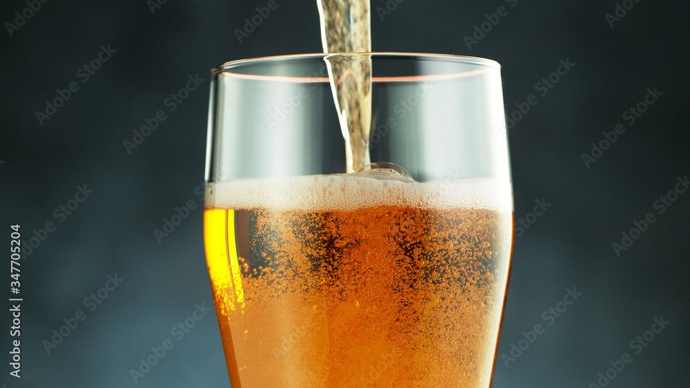 Close up of a wet pint of cold pale beer pouring