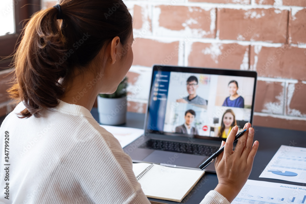 Young Asian businesswoman work at home and virtual video conference meeting with colleagues business