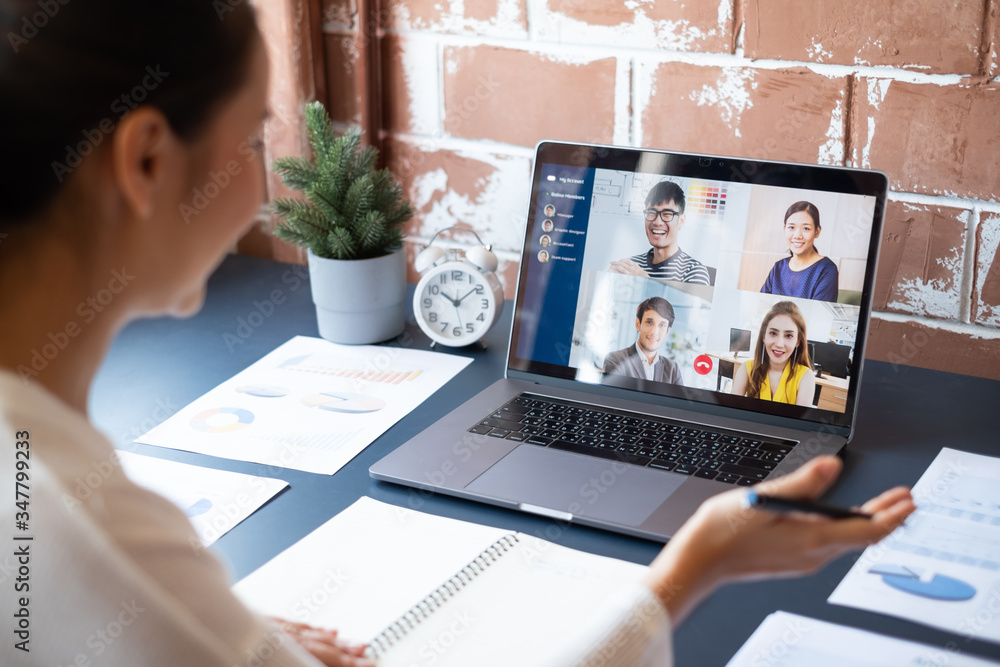 Young Asian businesswoman work at home and virtual video conference meeting with colleagues business