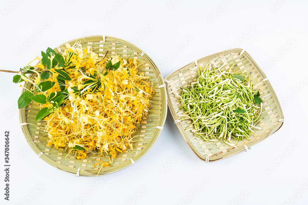 Bamboo sieve filled with fresh wild honeysuckle on white background