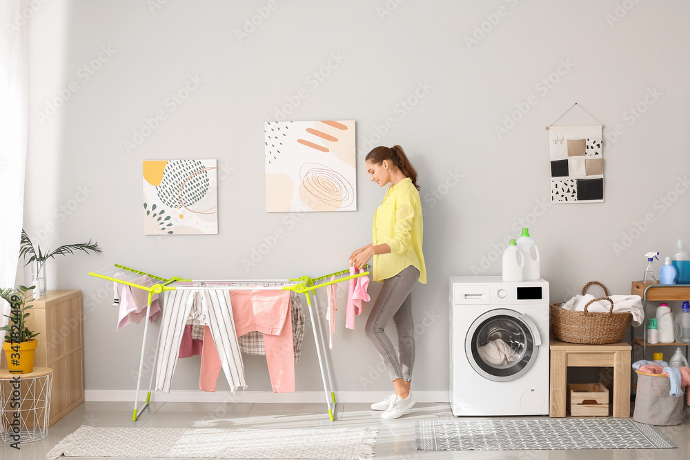 Young woman with clean laundry at home