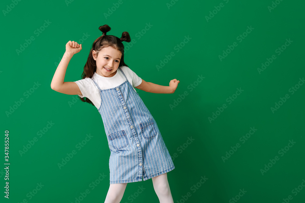 Cute dancing girl on color background