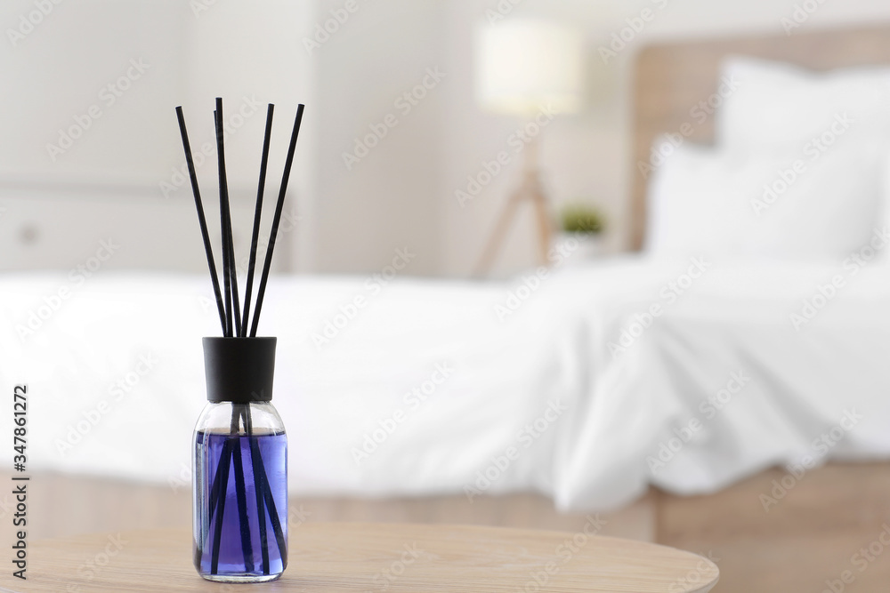 Reed diffuser on table in bedroom