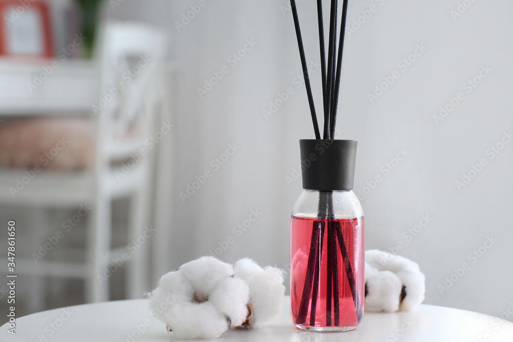 Reed diffuser on table in room