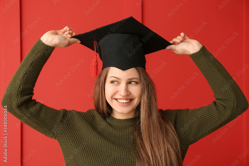 Female graduating student on color background