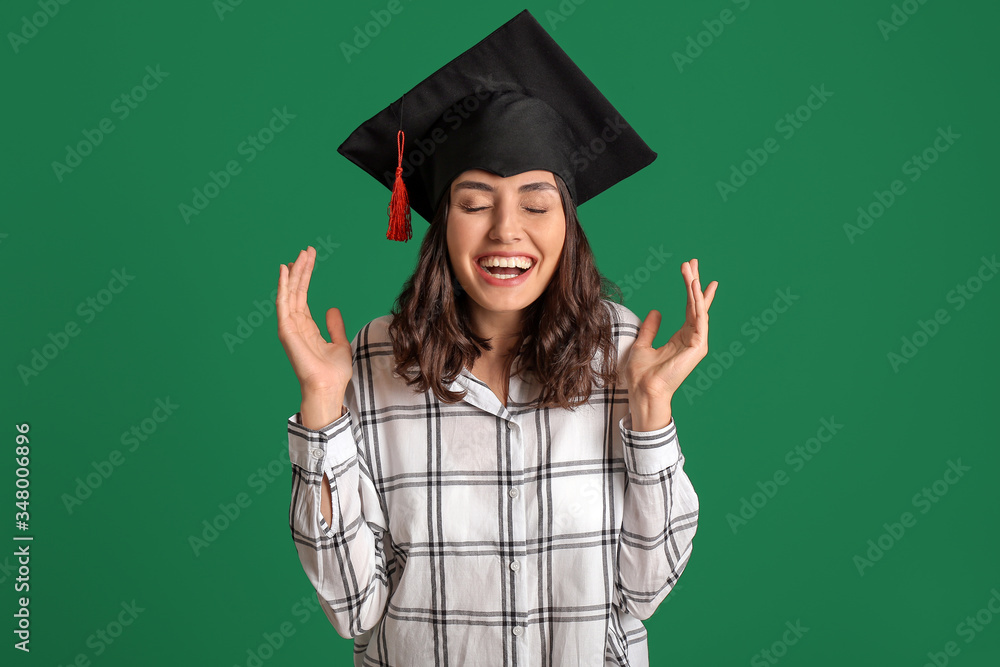 Happy female graduating student on color background