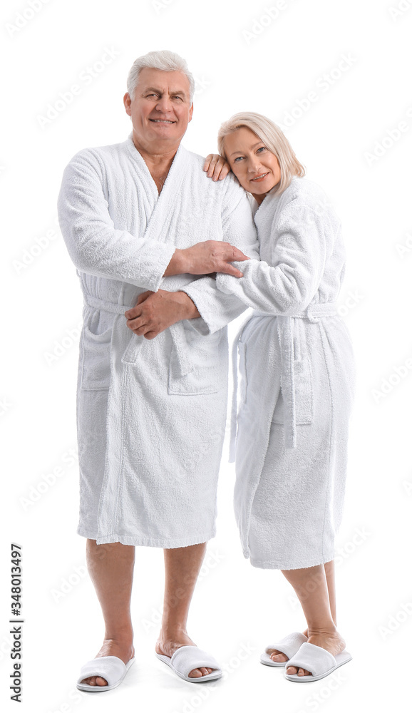 Mature couple in bathrobes on white background