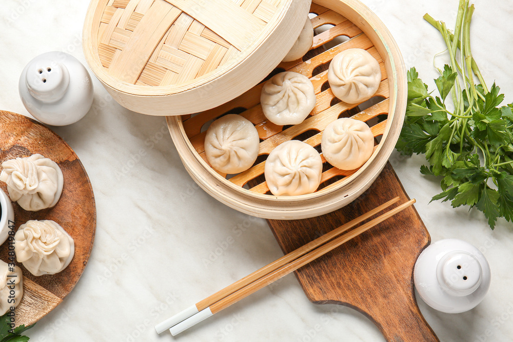 Steamer with tasty dumplings on table