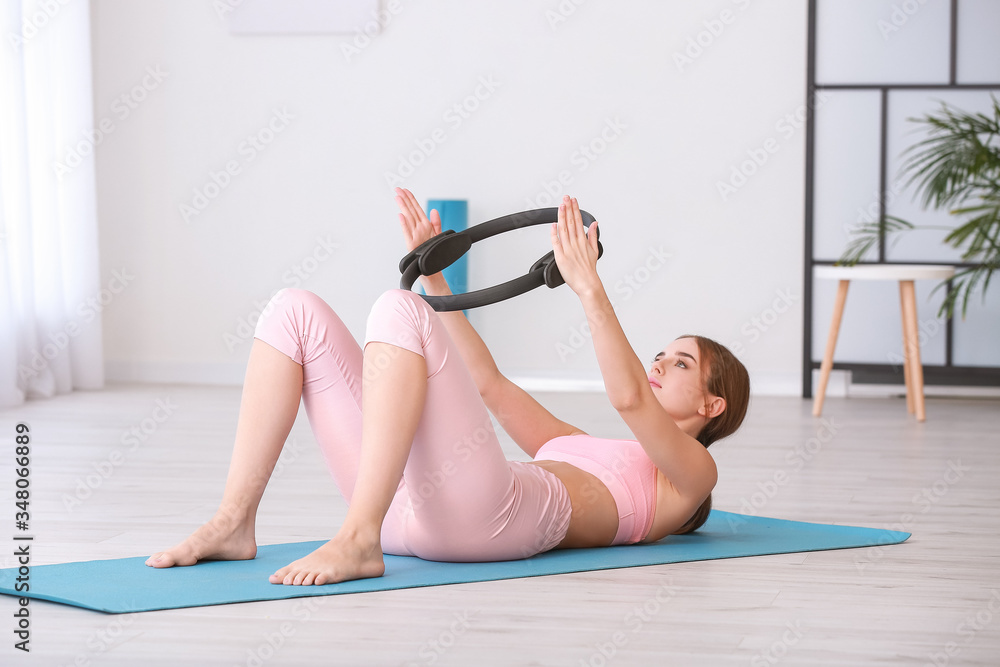 Sporty young woman training at home