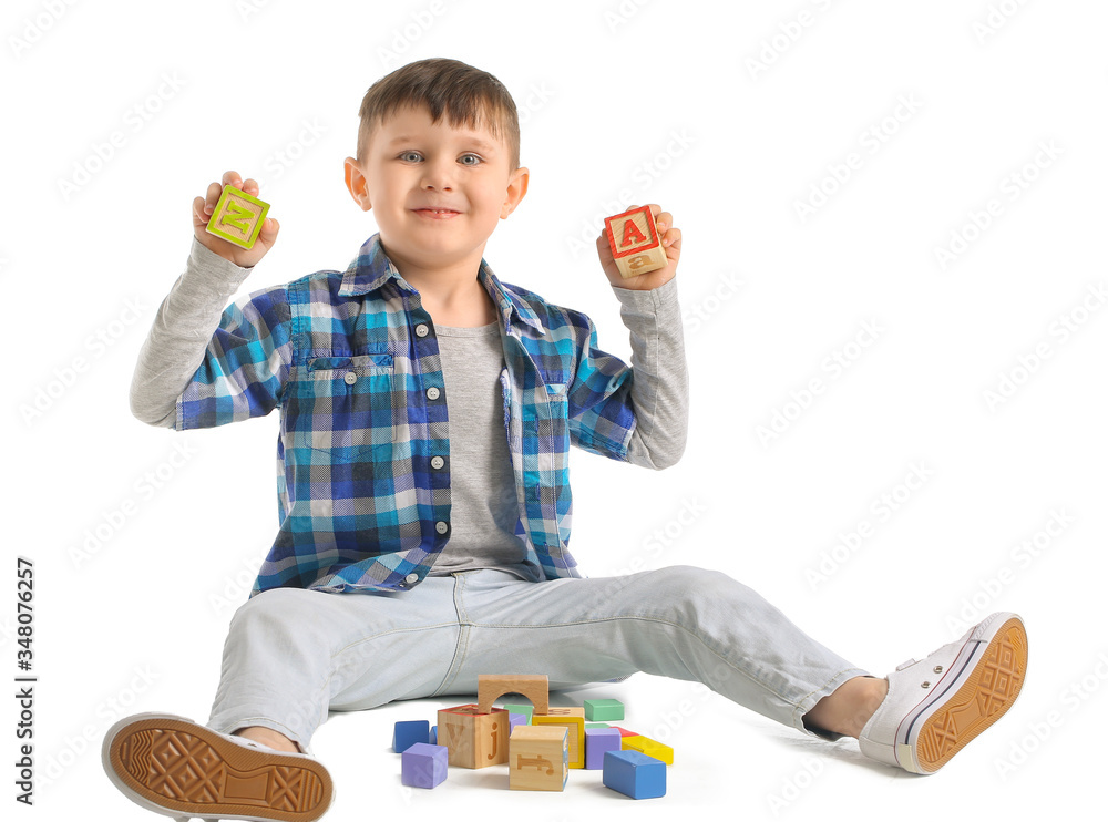 Little boy with toys on white background