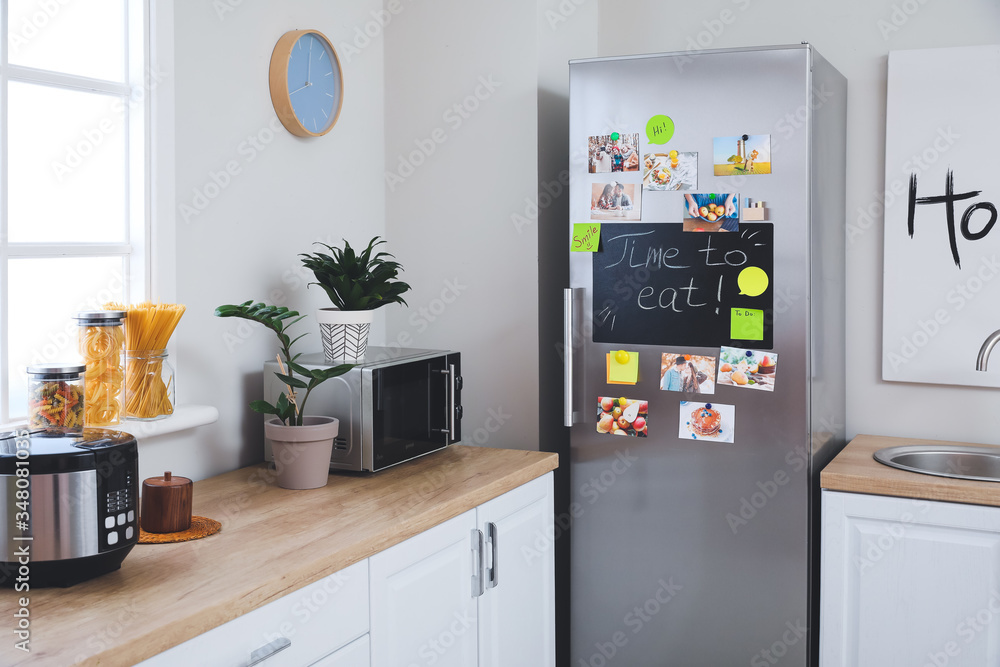 Stylish interior of modern kitchen with big refrigerator