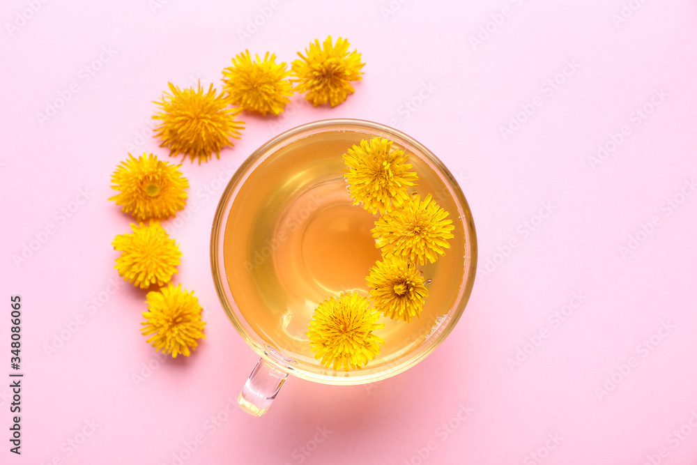 Cup of healthy dandelion tea on color background