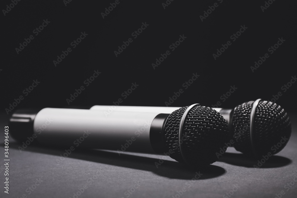 Modern microphones on dark background