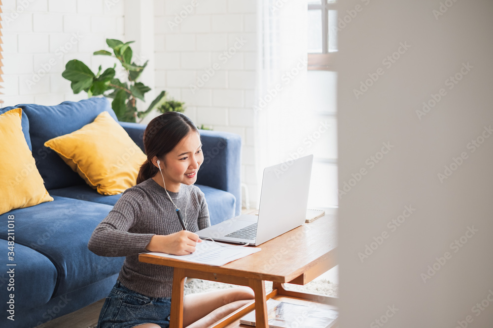 Young Asian businesswoman work at home and virtual video conference meeting with colleagues business