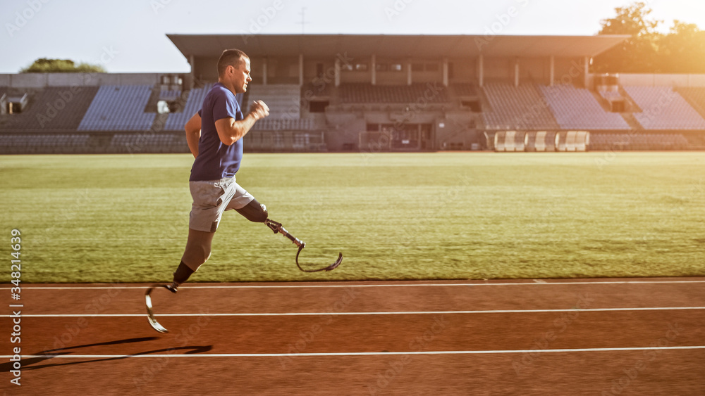 Athletic Disabled Fit Man with Prosthetic Running Blades is Training on an Outdoors Stadium on a Sun