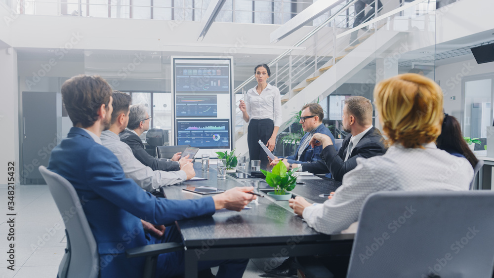 In the Corporate Meeting Room: Female Analyst Uses Digital Interactive Whiteboard for Presentation t