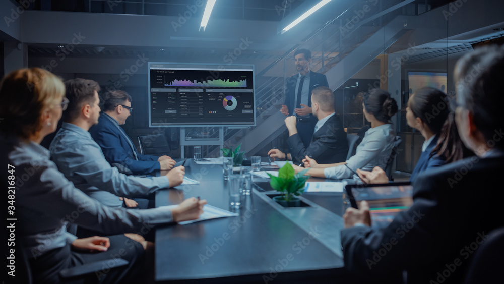 In the Corporate Meeting Room: Male Executive Talks and Uses Digital Interactive Whiteboard for Pres