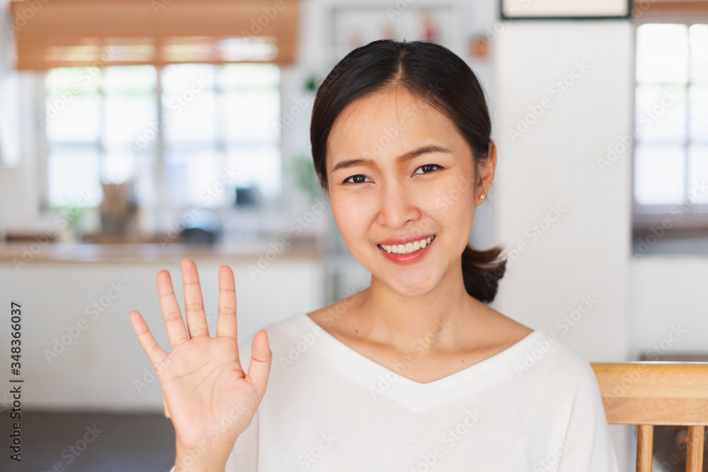 Portrait young Asian businesswoman work at home and virtual video conference meeting with colleagues