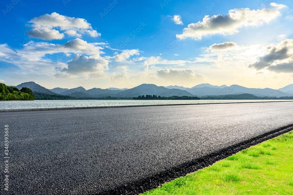 Asphalt road ground and mountain landscape at sunset.